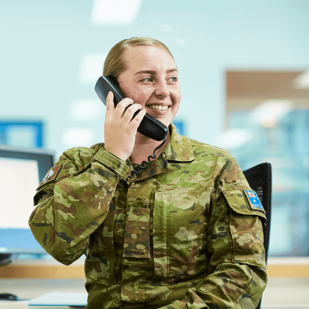 A female officer in uniform speaking on the phone.