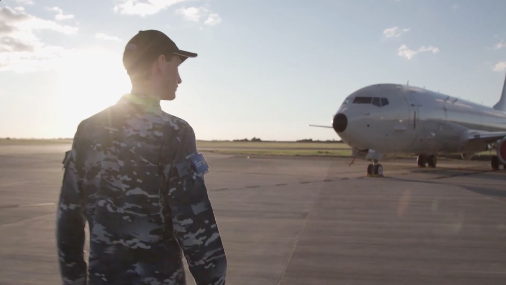 An Air Force member walking towards an airplane.