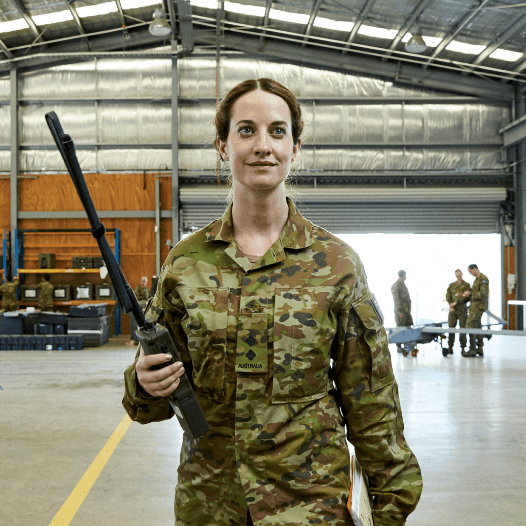 Army Officer Ellies walks through a military warehouse.Tara