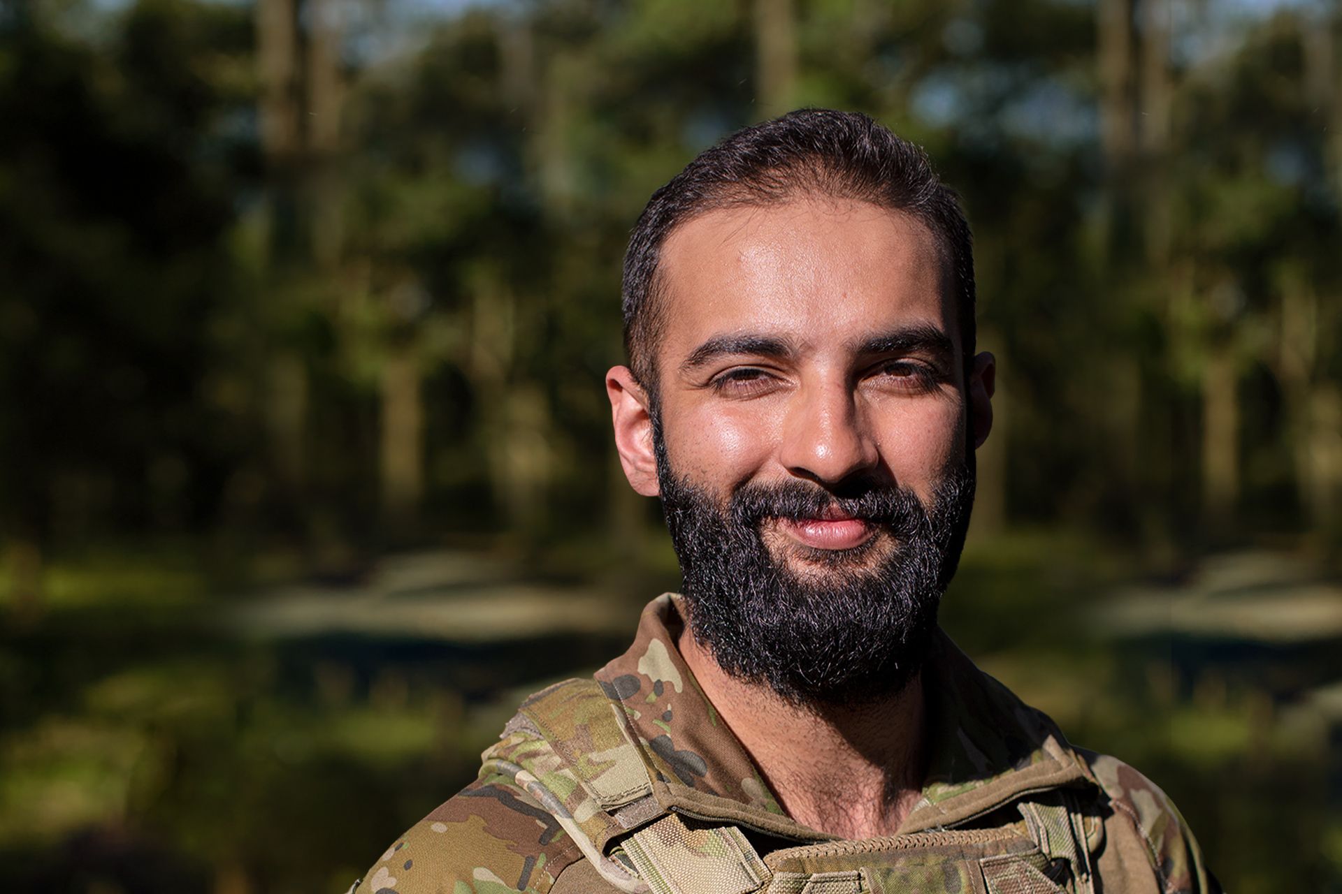 Army Reserve Officer Ammar smiles at camera.