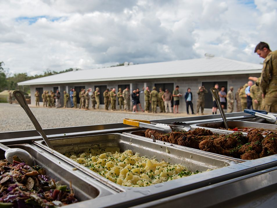 A line forms for a delicious buffet of food .