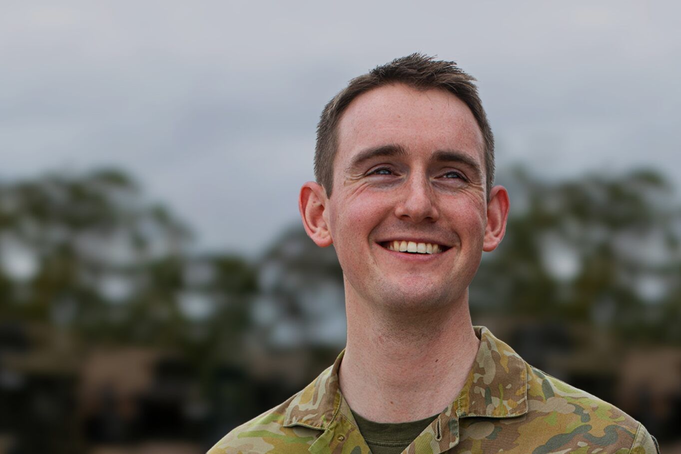 Army Reserve Officer Matthew smiles at camera.