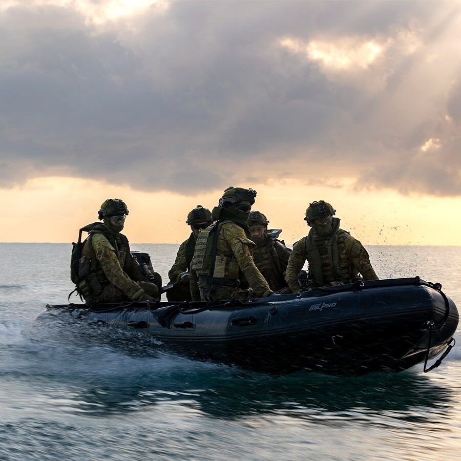 Five members of the Army are in a rubber ducky.