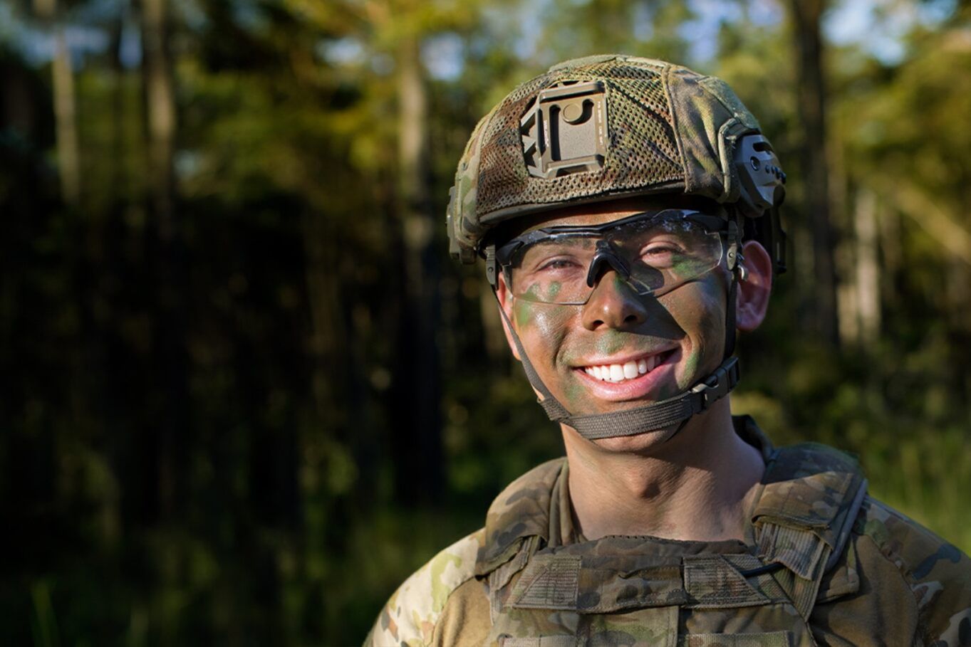 Army Reserve Infantry Soldier Simon is in full camouflage gear,  smiling at camera.