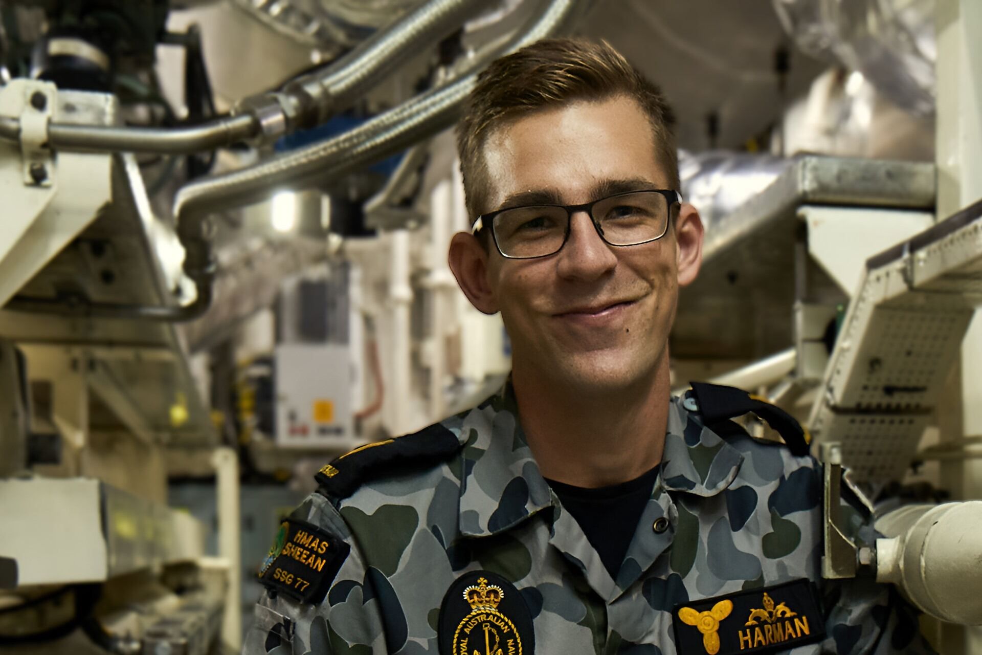 Marine Technician Submariner Cooper smiles at camera.