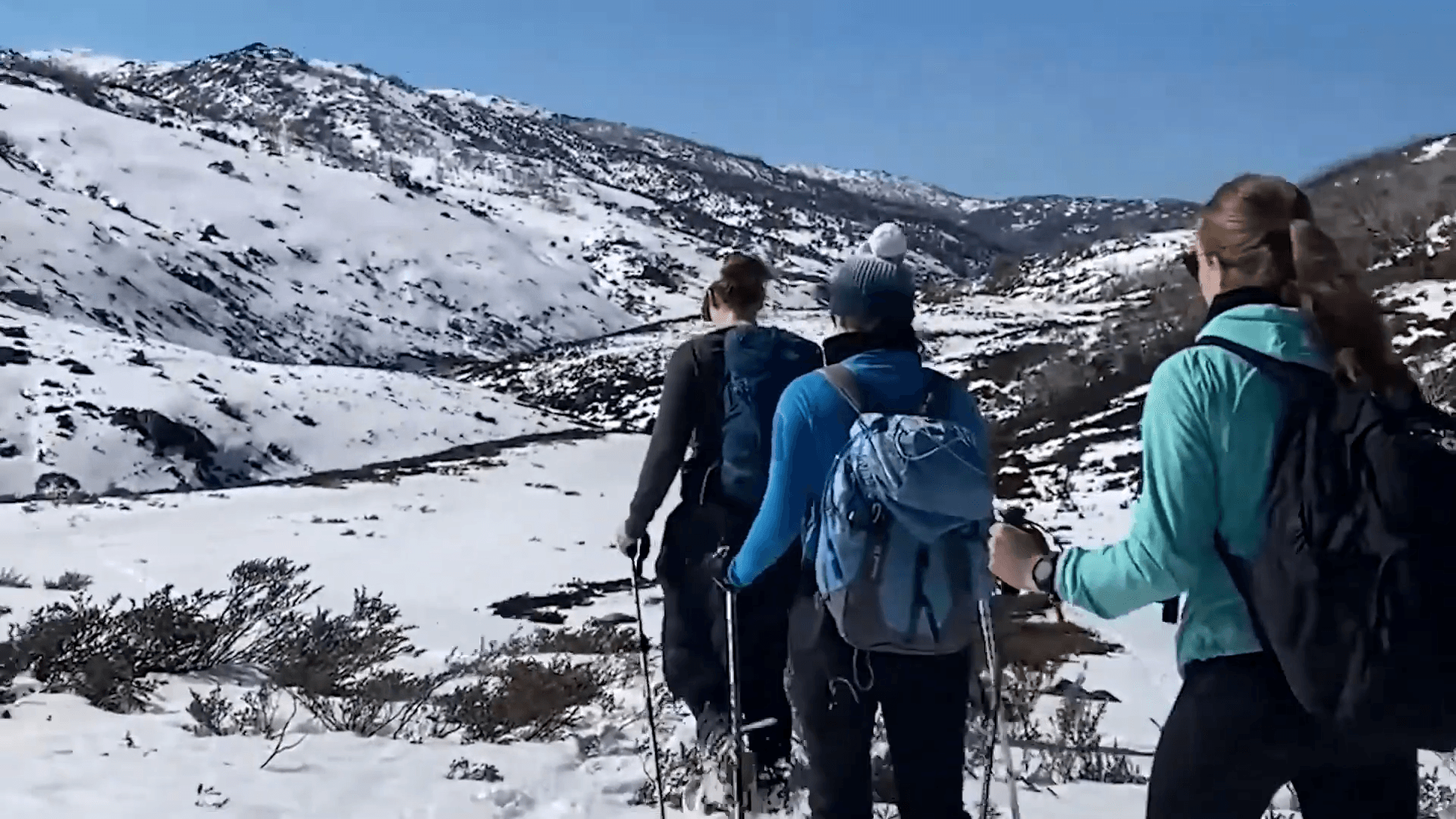 A group of people outside hiking in the snow