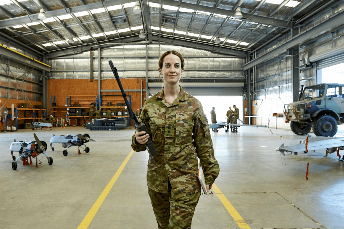Army Officer Ellies walks through a military warehouse.