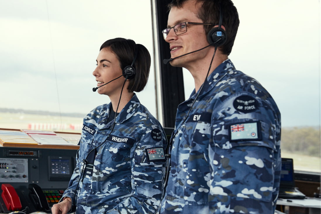 Two members of the Air Force wearing headsets.