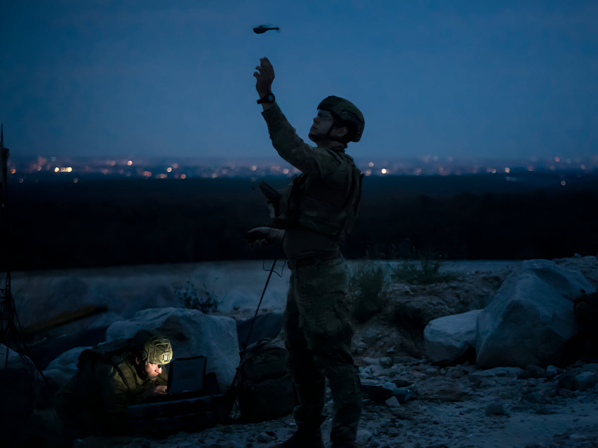 A member of the Army looks up into the night sky.